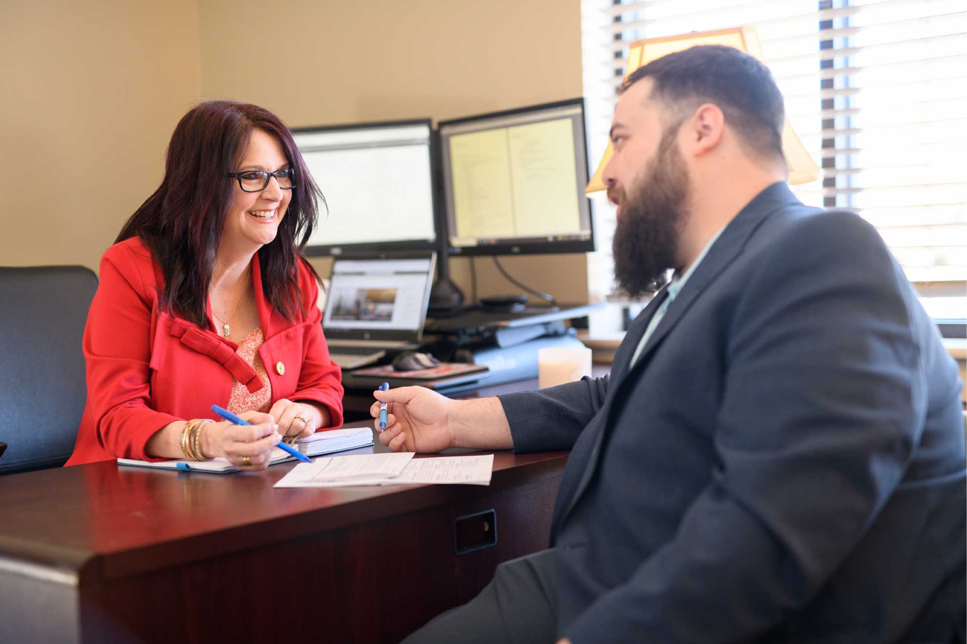 Two people talking in an office. 